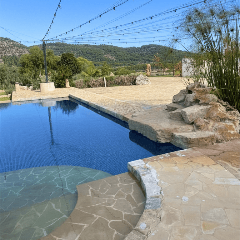 The pool terrace at Finca Son Vila in Mallorca, with Tramuntana mountains and fairy lights
