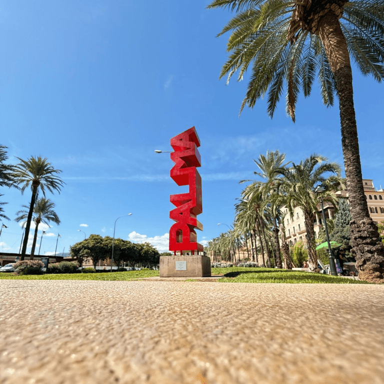 The Palma sign with palm trees and blue sky, Mallorca
